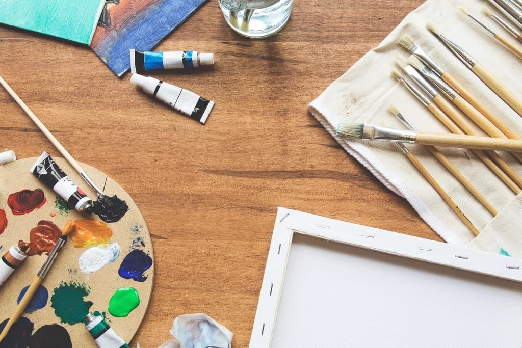 Brushes, a palette and paints on a table